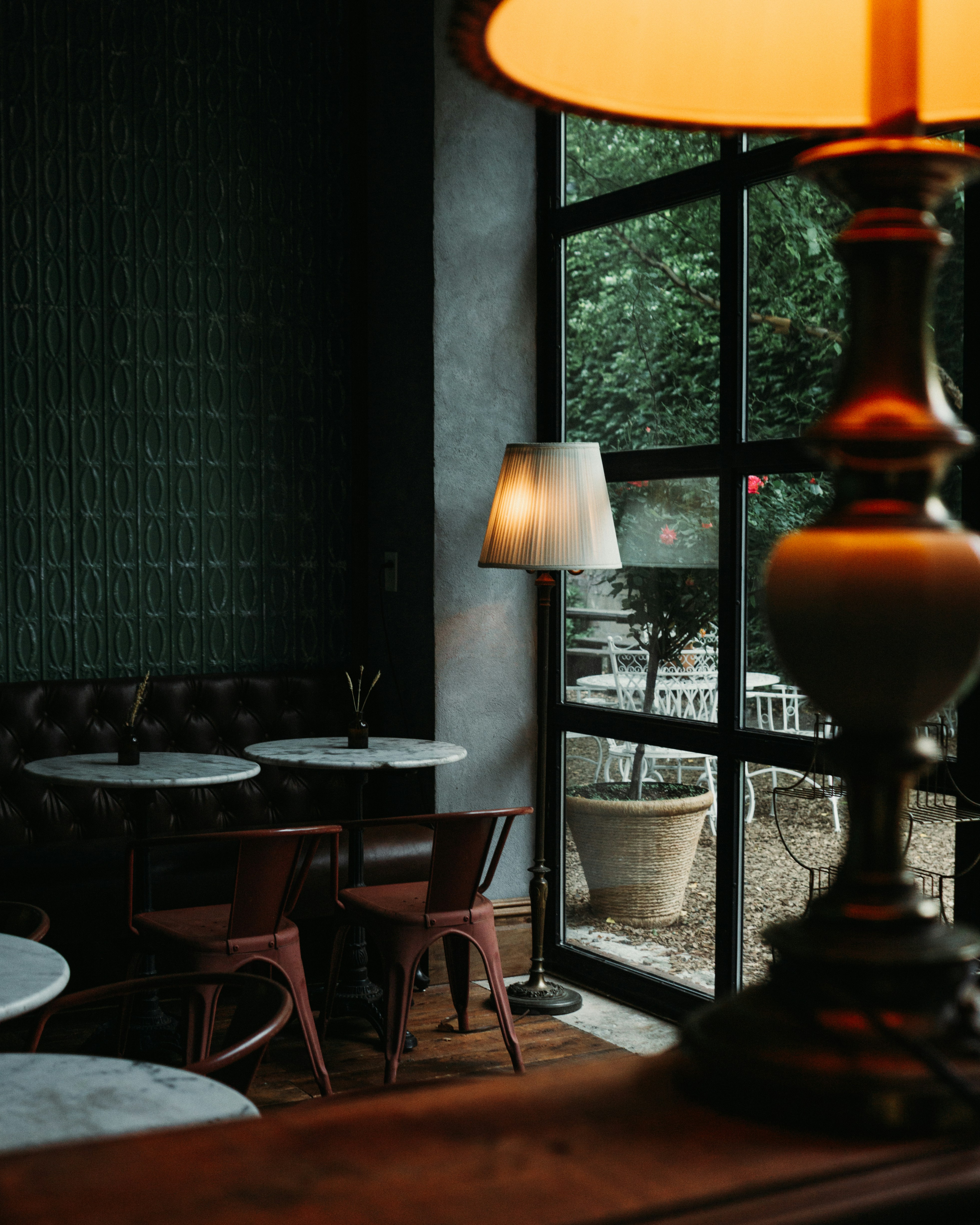 Dark moody restaurant interior with tables and chairs